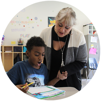 Teacher helping male student with classwork