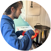 Male student cooking spaghetti